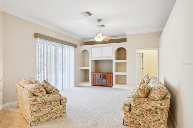 sitting room featuring crown molding, light colored carpet, and ceiling fan