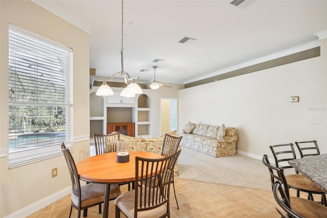 tiled dining room featuring ornamental molding, a healthy amount of sunlight, built in features, and ceiling fan