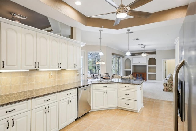 kitchen with kitchen peninsula, white cabinetry, stainless steel appliances, and dark stone counters