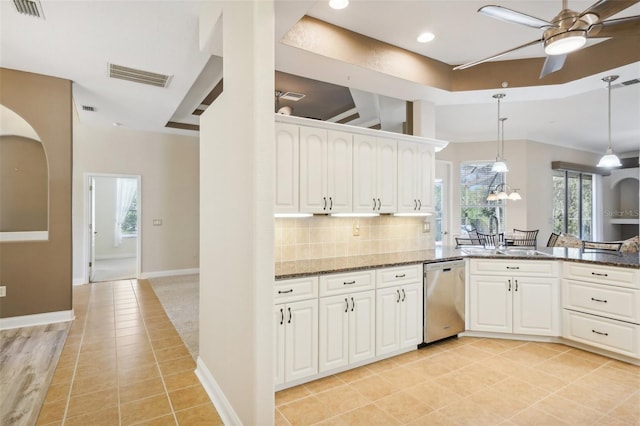 kitchen featuring sink, dishwasher, dark stone counters, and white cabinets