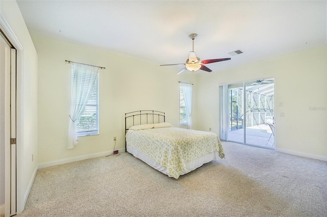 carpeted bedroom featuring ceiling fan, multiple windows, and access to exterior