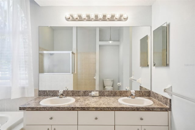 full bathroom featuring vanity, toilet, and shower with separate bathtub