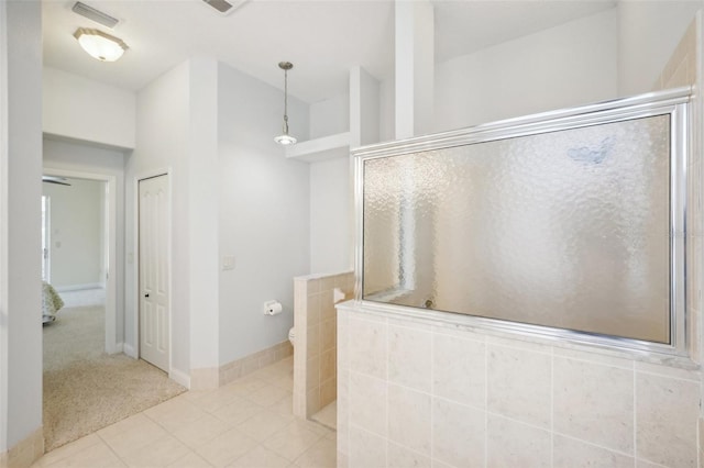 bathroom with tile patterned floors and a shower