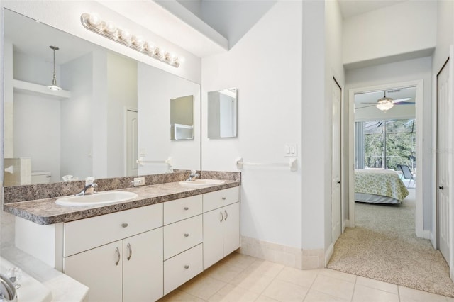 bathroom featuring toilet, vanity, tile patterned floors, and ceiling fan