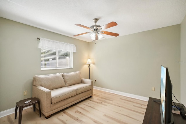 living area featuring ceiling fan and light hardwood / wood-style flooring