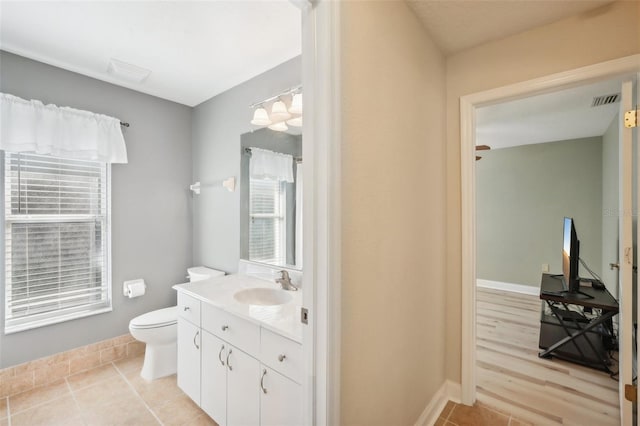 bathroom featuring toilet, vanity, and wood-type flooring