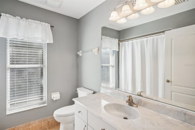 bathroom featuring vanity, toilet, and tile patterned flooring