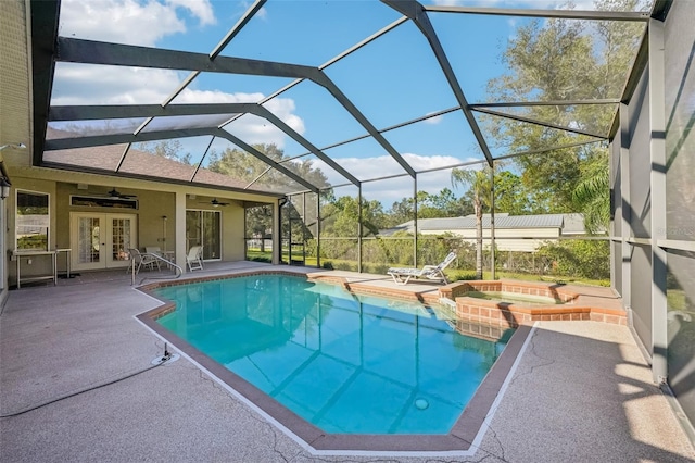 view of pool featuring ceiling fan, a patio, a lanai, french doors, and an in ground hot tub