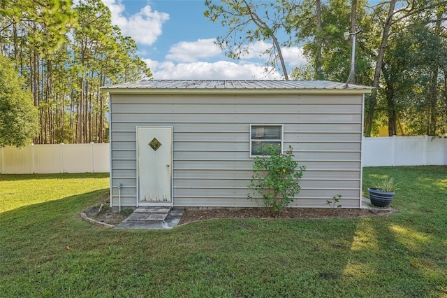 view of outbuilding with a yard