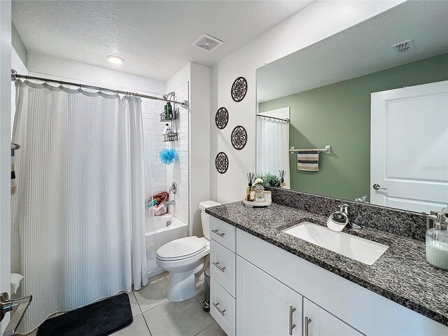 full bathroom with shower / bathtub combination with curtain, tile patterned floors, a textured ceiling, toilet, and vanity