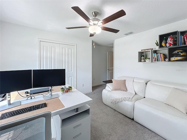 carpeted office with ceiling fan