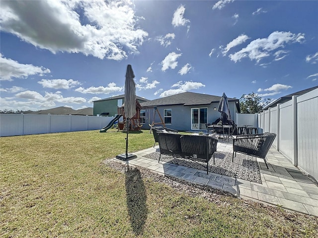 view of yard featuring an outdoor hangout area, a playground, and a patio area