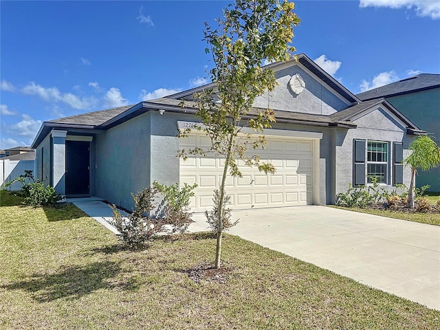 view of front of home featuring a garage and a front lawn