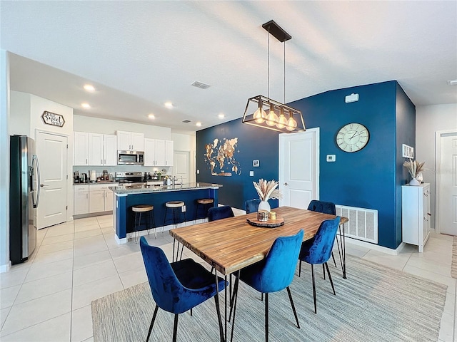 tiled dining space featuring sink