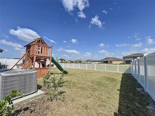 view of yard featuring a playground and central AC