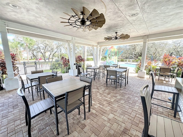 view of patio featuring a fenced in pool and ceiling fan