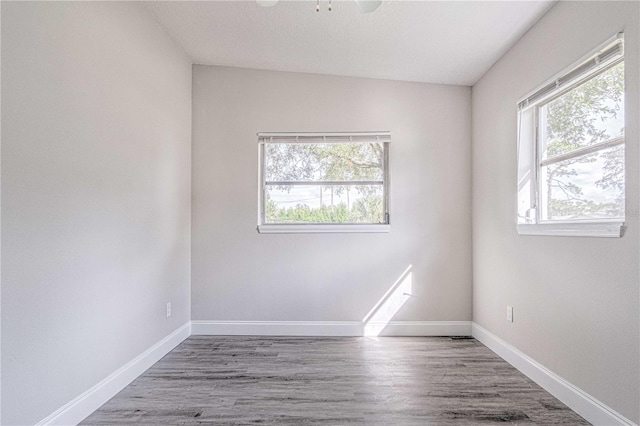 unfurnished room featuring ceiling fan, wood-type flooring, and lofted ceiling