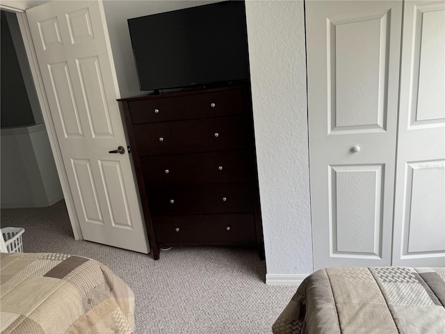 carpeted bedroom featuring a closet