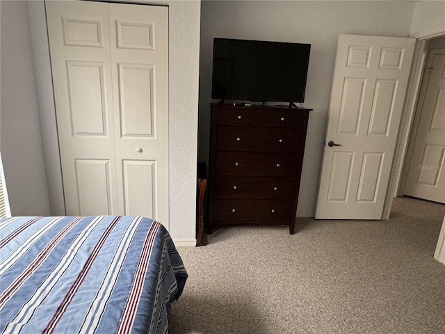 carpeted bedroom featuring a closet