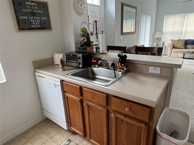 kitchen featuring sink, light tile patterned floors, and dishwasher