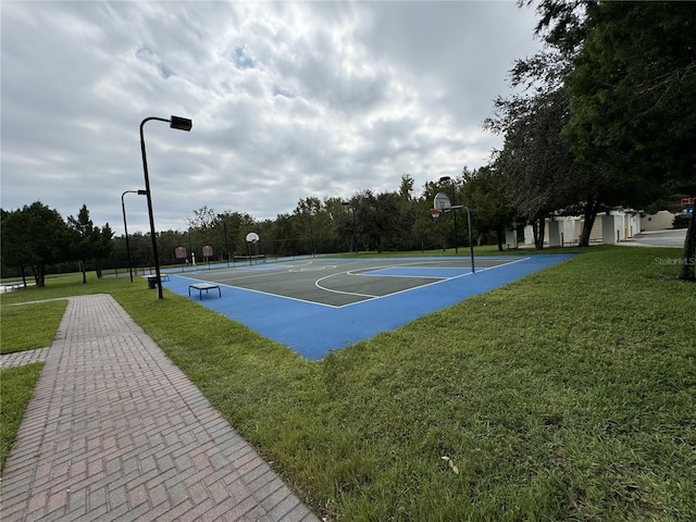 view of basketball court featuring a yard