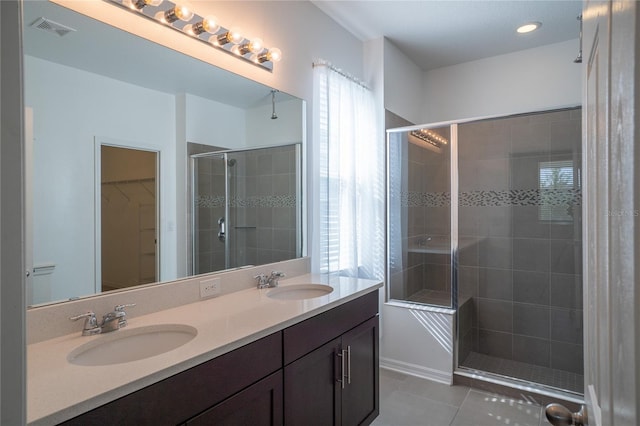 bathroom with vanity, tile patterned floors, and walk in shower