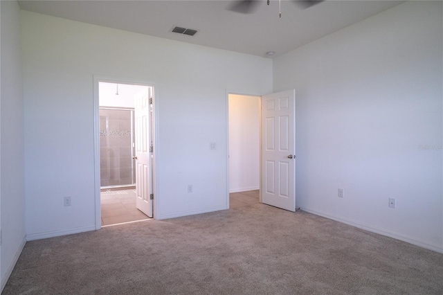 unfurnished bedroom with ensuite bathroom and light colored carpet