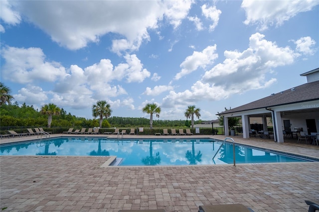 view of swimming pool featuring a patio area