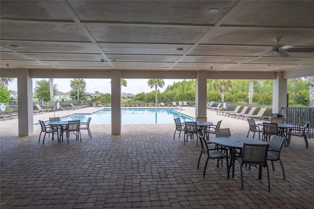 view of patio featuring a community pool and ceiling fan