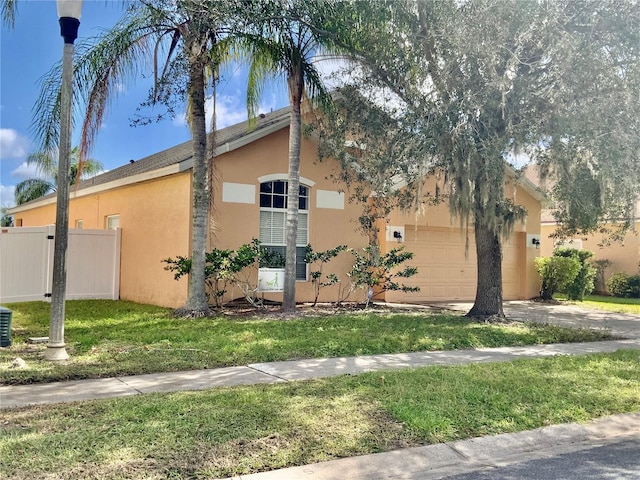 view of home's exterior with a lawn and a garage