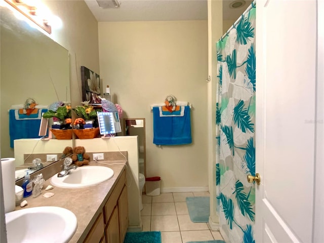 bathroom with vanity, curtained shower, toilet, and tile patterned flooring