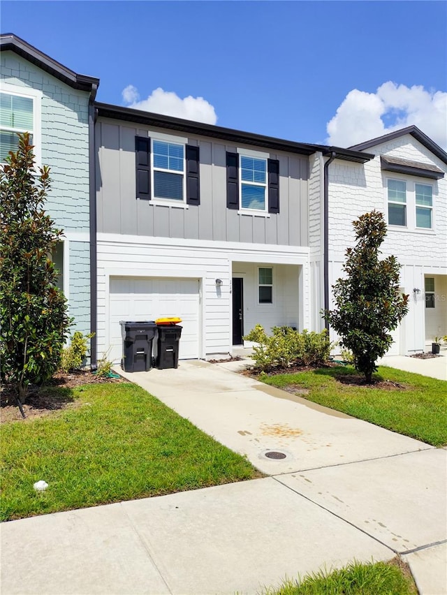 view of front of home featuring a garage and a front lawn