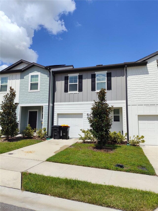 114 Mandovi St, Davenport, FL 33837 - multi unit property featuring board and batten siding, concrete driveway, and a garage