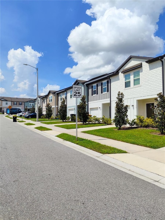 114 Mandovi St, Davenport, FL 33837 - townhome / multi-family property featuring board and batten siding, a residential view, and a front yard