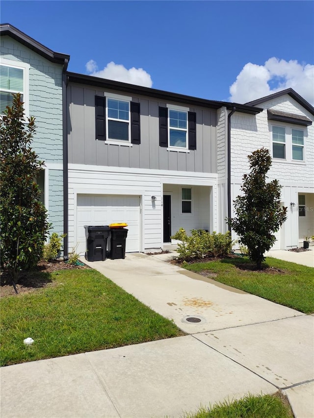 114 Mandovi St, Davenport, FL 33837 - view of property featuring an attached garage, board and batten siding, driveway, and a front lawn