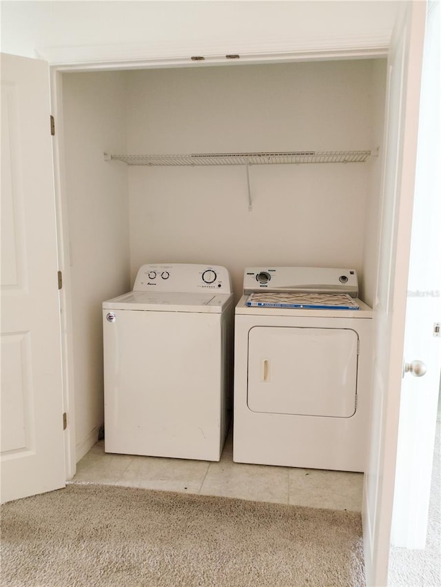 laundry area with light carpet and separate washer and dryer