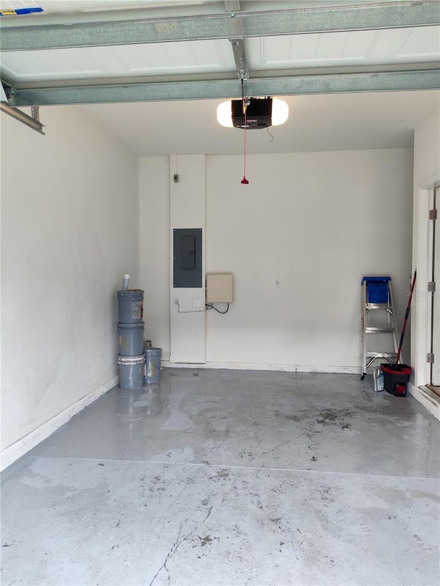 114 Mandovi St, Davenport, FL 33837 - garage with electric panel, a garage door opener, and baseboards