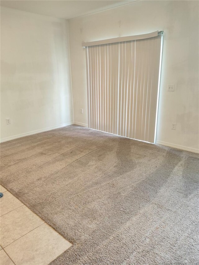 114 Mandovi St, Davenport, FL 33837 - carpeted spare room featuring baseboards and tile patterned floors