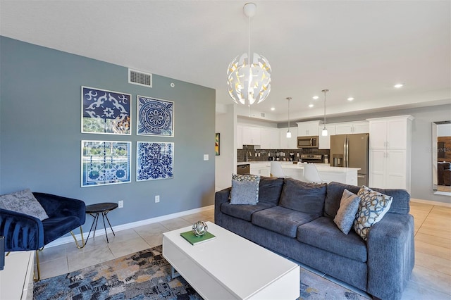 tiled living room featuring an inviting chandelier