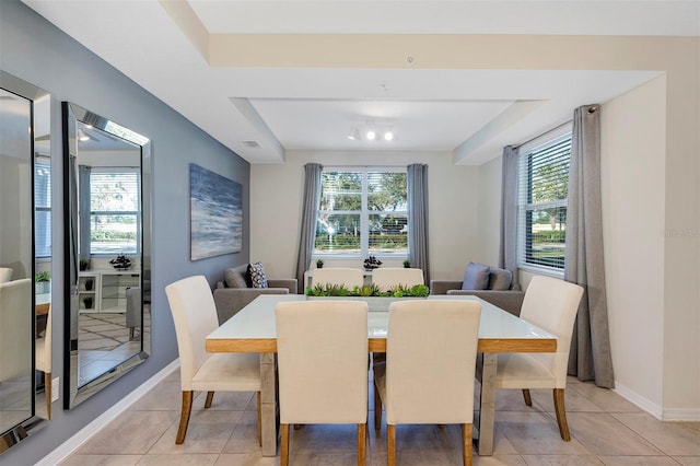 dining space with light tile patterned flooring and a wealth of natural light