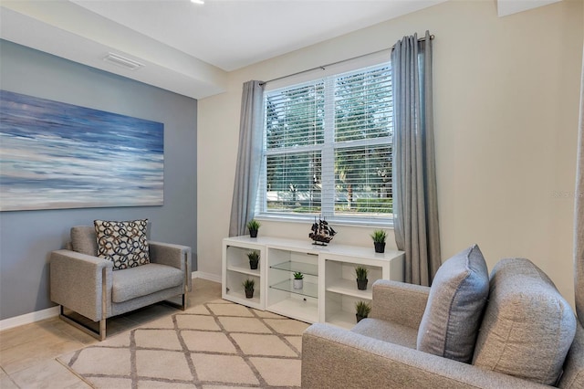 living area featuring light tile patterned flooring and a healthy amount of sunlight