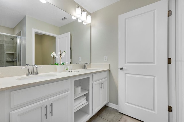 bathroom with vanity, walk in shower, and tile patterned floors