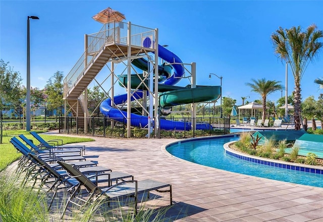 view of swimming pool with a patio and a water slide