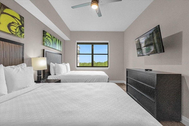 bedroom with dark hardwood / wood-style flooring and ceiling fan