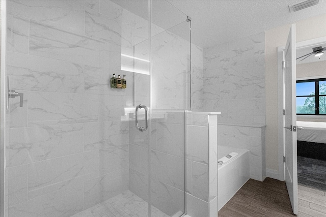 bathroom featuring independent shower and bath, wood-type flooring, and ceiling fan