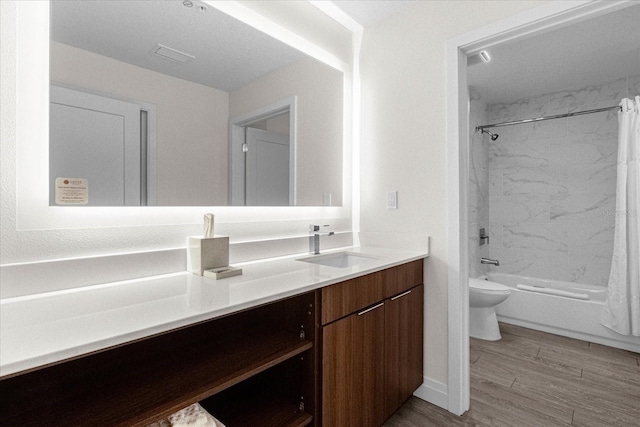 full bathroom featuring vanity, toilet, hardwood / wood-style flooring, and shower / bath combo