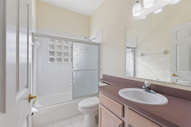 full bathroom featuring vanity, enclosed tub / shower combo, toilet, and tile patterned flooring