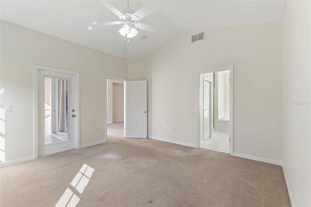 carpeted empty room featuring ceiling fan and lofted ceiling