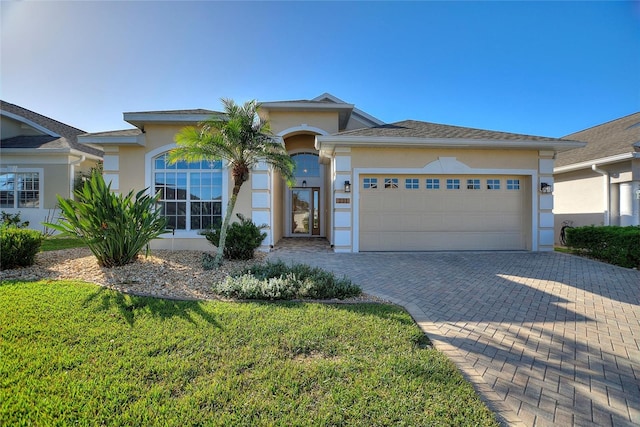 view of front of house featuring a front lawn and a garage