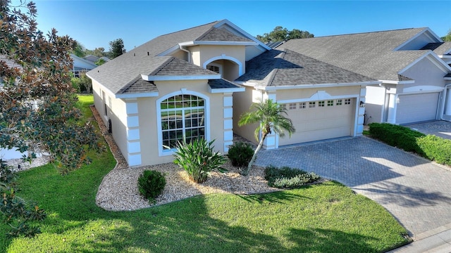 view of front facade featuring a front yard and a garage